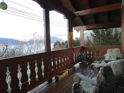 a screened in porch with a view of the mountains at Cosy chalet, 100m2 with fjordview! in Lauvstad