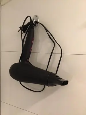 a black umbrella hanging on a wall at Sandvik Garasjeloft in Vossevangen
