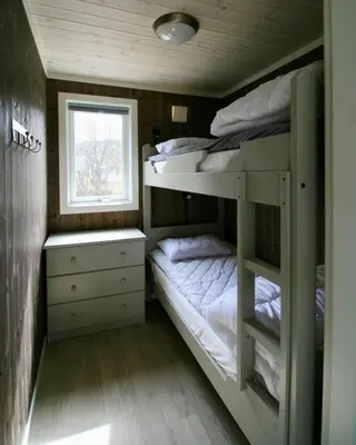 two bunk beds in a small room with a window at Bøflaten Camping AS in Vang I Valdres
