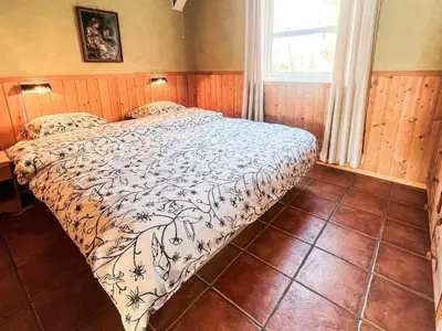 a bedroom with a bed with a comforter on it at 6 person holiday home in Leikanger in Leikanger