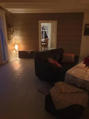 a living room with a couch and a table at Fjords view in Sjøholt