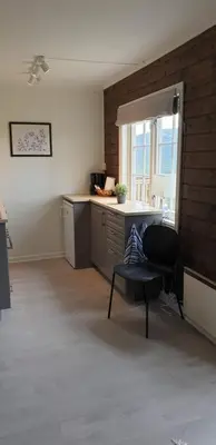 a kitchen with a chair and a desk and a window at Oppdal Alpintun Stølen ski in - ski out in Oppdal
