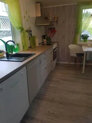 a kitchen with a sink and a counter top at Lille Villa Severin in Mosterhamn