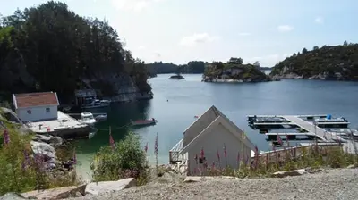a large body of water with a dock and boats at Havbris in Bremnes