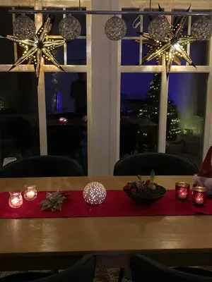 a table with christmas lights and candles on it at Havbris in Bremnes
