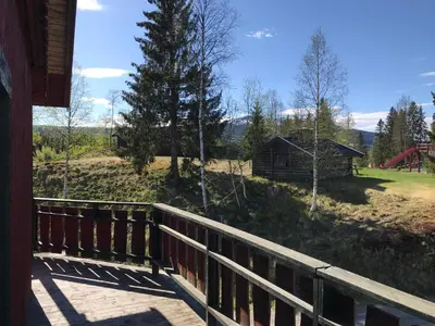 a porch of a house with a wooden fence at Trysil Motell & Vandrerhjem in Trysil