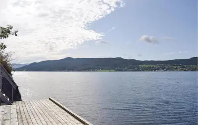 a dock with a view of a large body of water at Lovely Home In Sandvoll With Wifi in Sandvoll