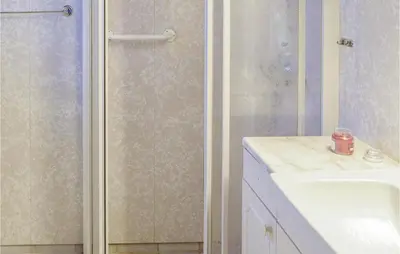 a bathroom with a shower and a sink and a counter at Awesome Home In Holmefjord in Holmefjord