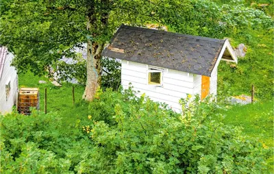 a small white dog house with a black roof at Awesome Home In Holmefjord in Holmefjord