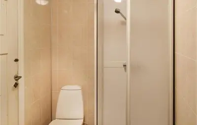 a bathroom with a toilet and a shower at 1 Bedroom Cozy Home In Vallavik in Kaland
