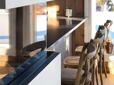a kitchen with a counter with chairs around it at 12 person holiday home in Fåvang in Favang