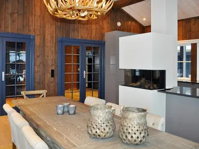 a dining room with a table and a kitchen at 12 person holiday home in Fåvang in Favang