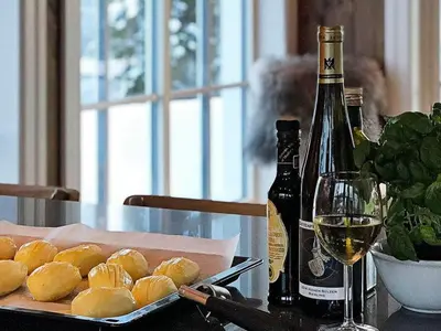 a table with a plate of food and a bottle of wine at 12 person holiday home in Fåvang in Favang