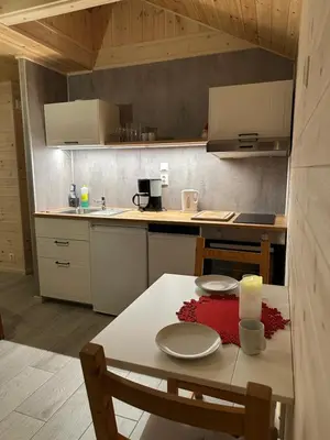 a kitchen with a table with a candle on it at Haugo Utleige Lodge in Vossevangen