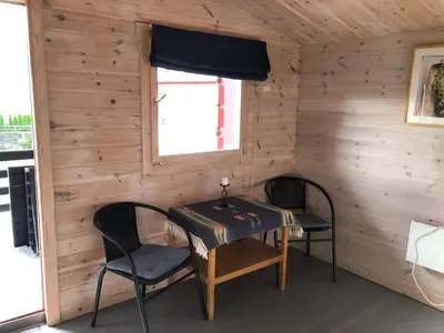 a room with a table and two chairs and a window at Haugo Utleige Lodge in Vossevangen