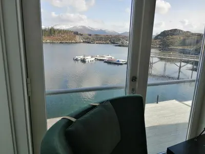 a window with a view of a body of water at Atlanterhavsveien Rorbuer in Averoy