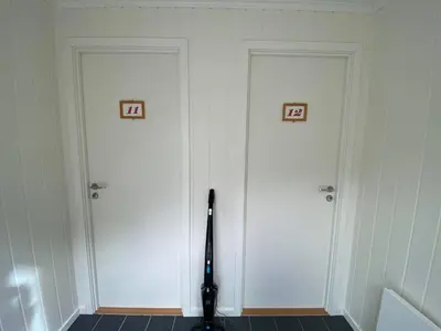 two white doors with numbers on them in a room at Botnen Camping in Botnen