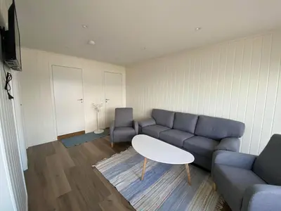 a living room with a couch and a table at Botnen Camping in Botnen