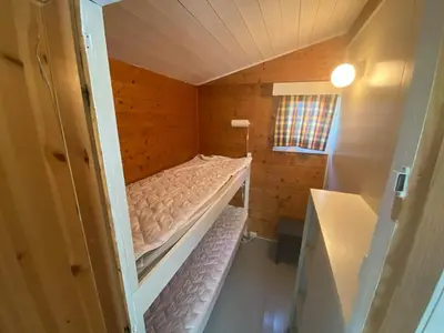 a small room with a bunk bed in a house at Botnen Camping in Botnen