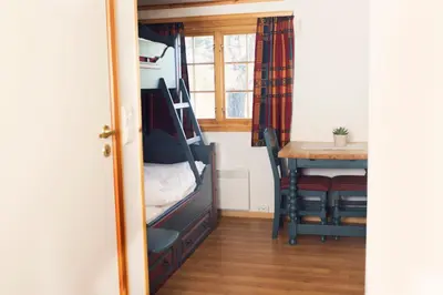 a room with a bunk bed and a table at Rondaplassen in Kvam