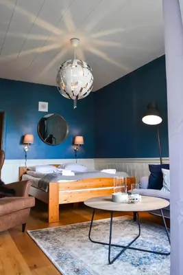 a living room with a bed and a table at Ingrids Apartments in Eidfjord