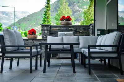 a table and chairs sitting on a patio with a view at Ingrids Apartments in Eidfjord
