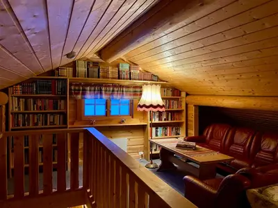 a living room with a couch and a table in a cabin at Hakkesetstølen Fjellstugu in Geilo