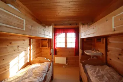 a room with two bunk beds and a sink at Hakkesetstølen Fjellstugu in Geilo