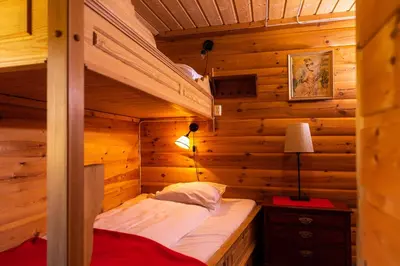 a bedroom with a bunk bed in a log cabin at Hakkesetstølen Fjellstugu in Geilo
