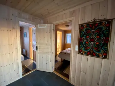 a room with two doors and a painting on the wall at Hakkesetstølen Hytter in Geilo