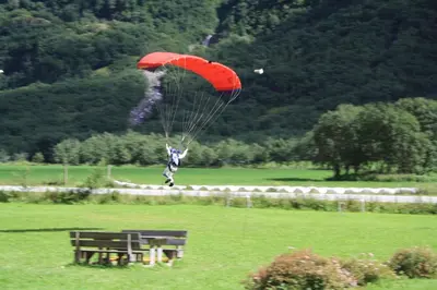a person riding a parachute in a field at Gudvangen Camping in Gudvangen