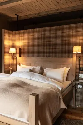 a bedroom with a large bed with two lamps at Storfjord Hotel in Skodje