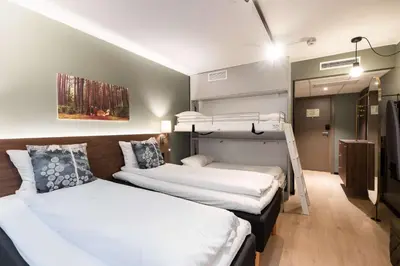 two beds in a room with two bunk beds at Scandic Hell in Hell