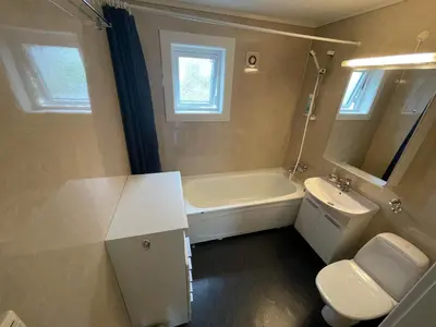 a bathroom with a tub and a sink and a toilet at Åndalsnes Apartments - Luxury Stay in Åndalsnes
