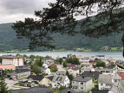 a town with a river and a town with houses at Åndalsnes Apartments - Luxury Stay in Åndalsnes