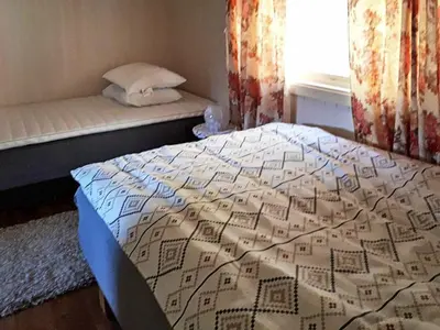 a bedroom with a bed and a window at 8 person holiday home in EIDSVÅG in Eidsvåg