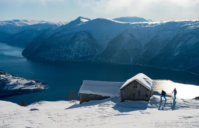 two people standing on top of a snow covered mountain at Nes Gard in Høyheimsvik