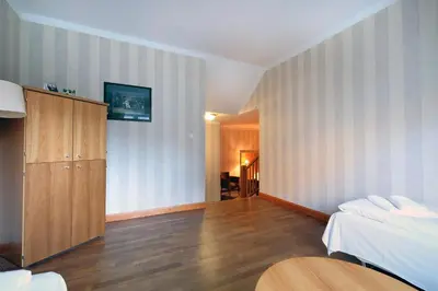 a hotel room with a bed and a cabinet at Vøringfoss Hotel in Eidfjord