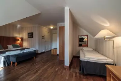 a hotel room with two beds and a staircase at Vøringfoss Hotel in Eidfjord
