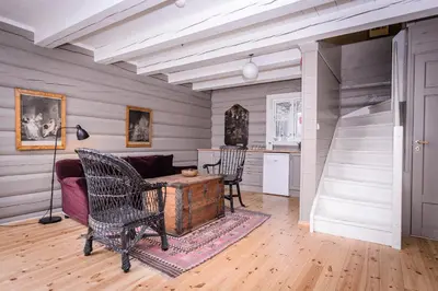 a living room with a couch and a table and chairs at Kleivstua Hotel near Krokskogen in Sundvollen