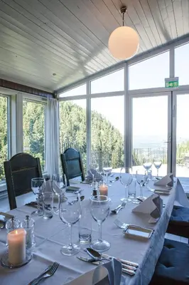 a long table with wine glasses and candles on it at Kleivstua Hotel near Krokskogen in Sundvollen