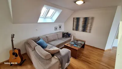 a living room with a couch and a guitar at Penthouse with perfect location and spectacular view in Bergen