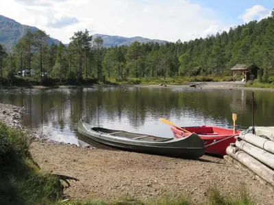 two canoes sitting on the shore of a lake at Hov Hyttegrend in Viksdalen
