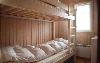 an empty bunk bed in a room with a window at Four-Bedroom Holiday Home In Eggedal in Eggedal
