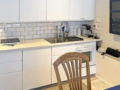 a kitchen with a sink and a chair in it at 10 person holiday home in Brattvåg in Brattvåg
