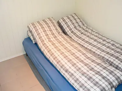 a blue couch with a checkered blanket on it at 10 person holiday home in Brattvåg in Brattvåg