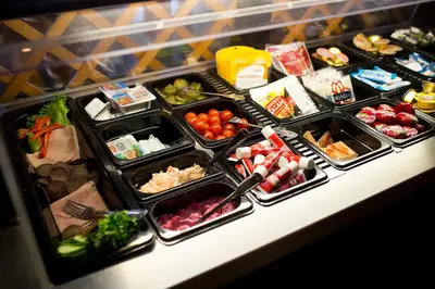 a buffet filled with different types of food on a counter at Motell Nor-Kro in Bromma