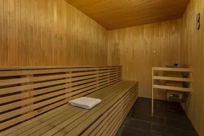 a sauna with a white towel sitting on a bench at Frichs Hotel Hamar in Hamar