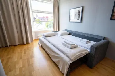 a small bed in a room with a window at Scandic Kristiansund in Kristiansund