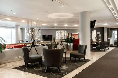 a lobby with chairs and a bar in a building at Scandic Kristiansund in Kristiansund